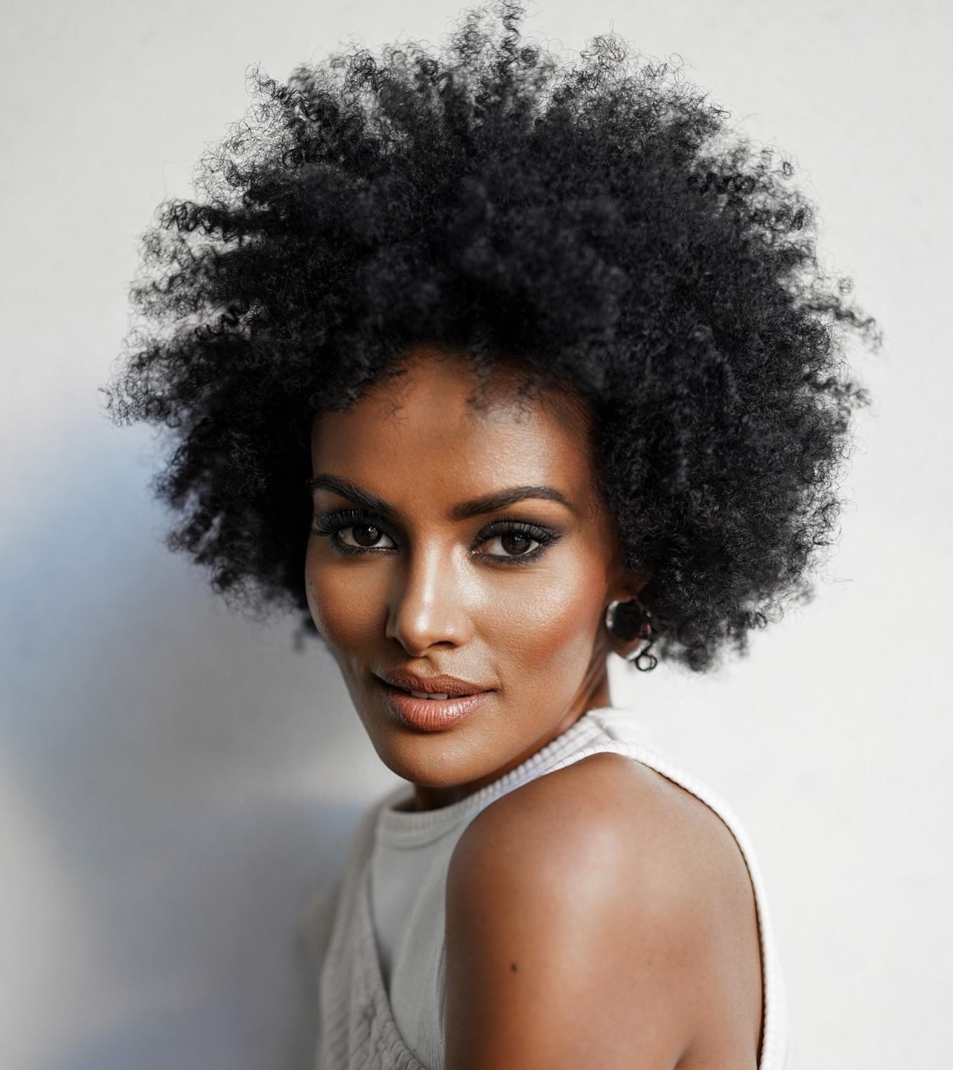 Short Curly Haircut on Dark-Skinned Woman